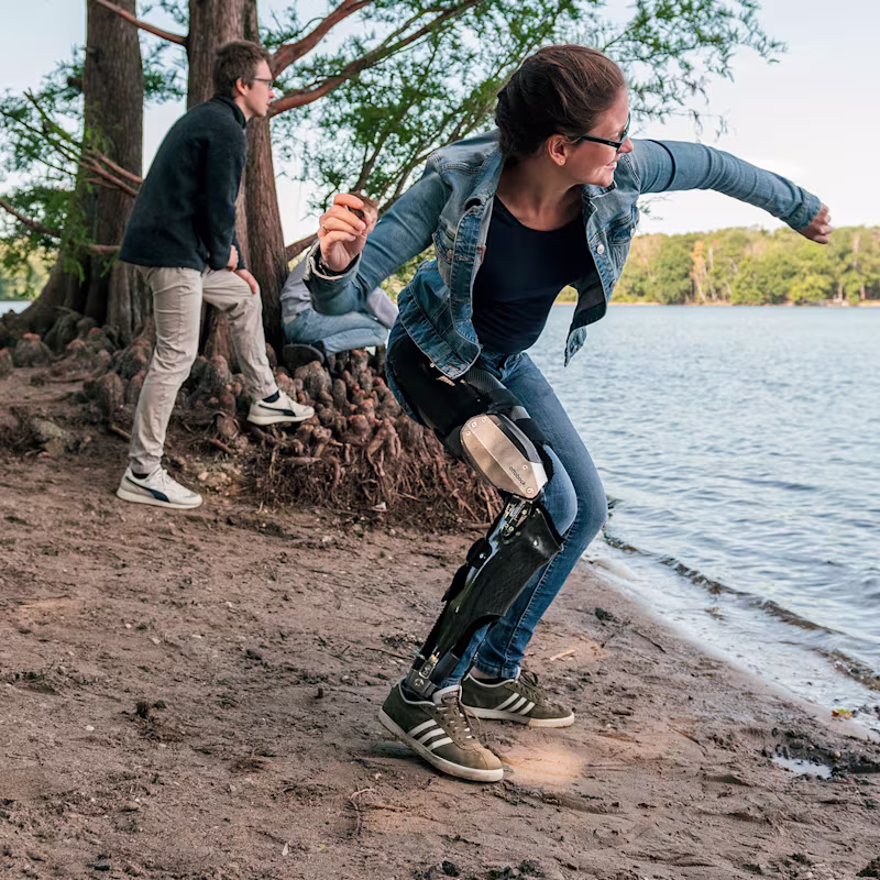 Denise al lago che lancia un sasso con il suo C-Brace