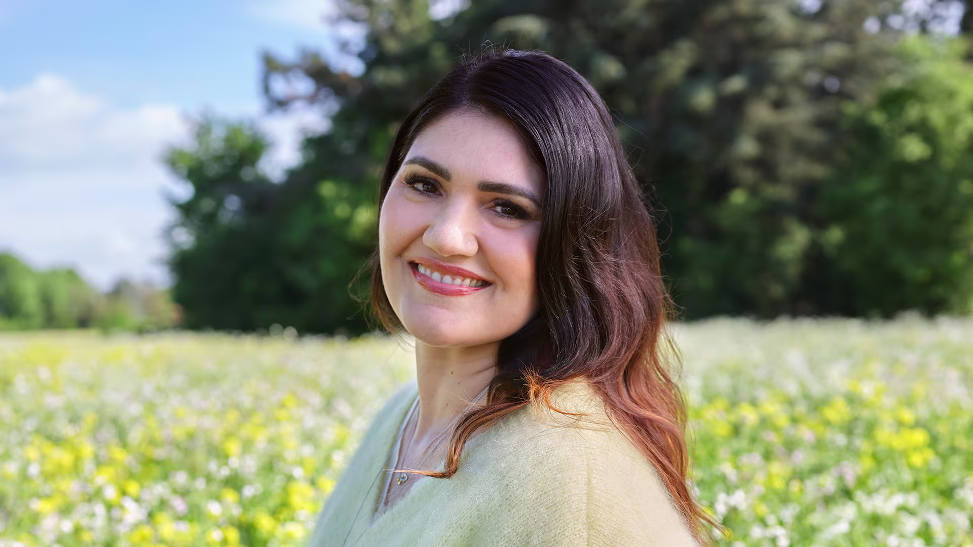 Ottobock Exopulse Mollii Suit user Elisa smiling in flower field