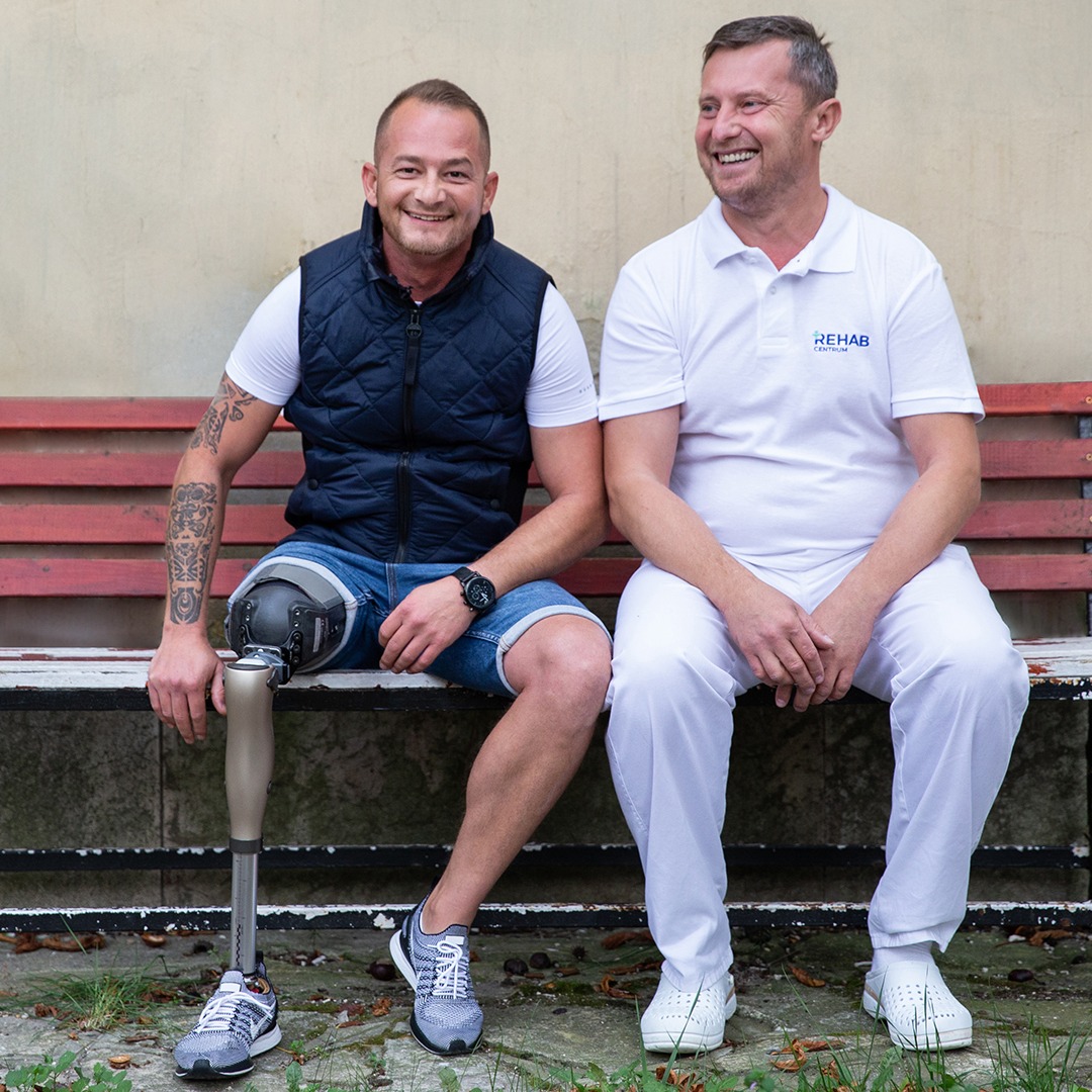 Laszlo and CPO sitting on a bank