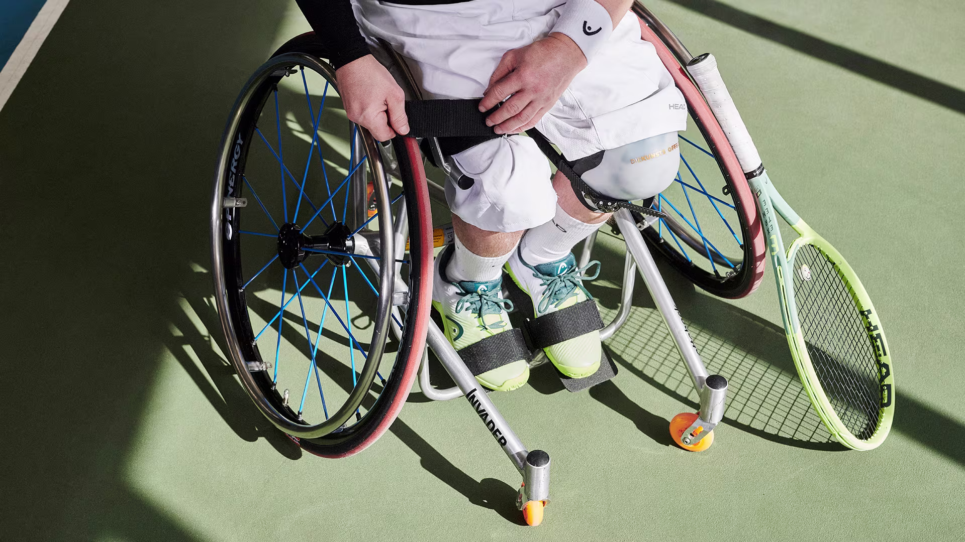 Person in the Ottobock Invader tennis wheelchair fastens the straps