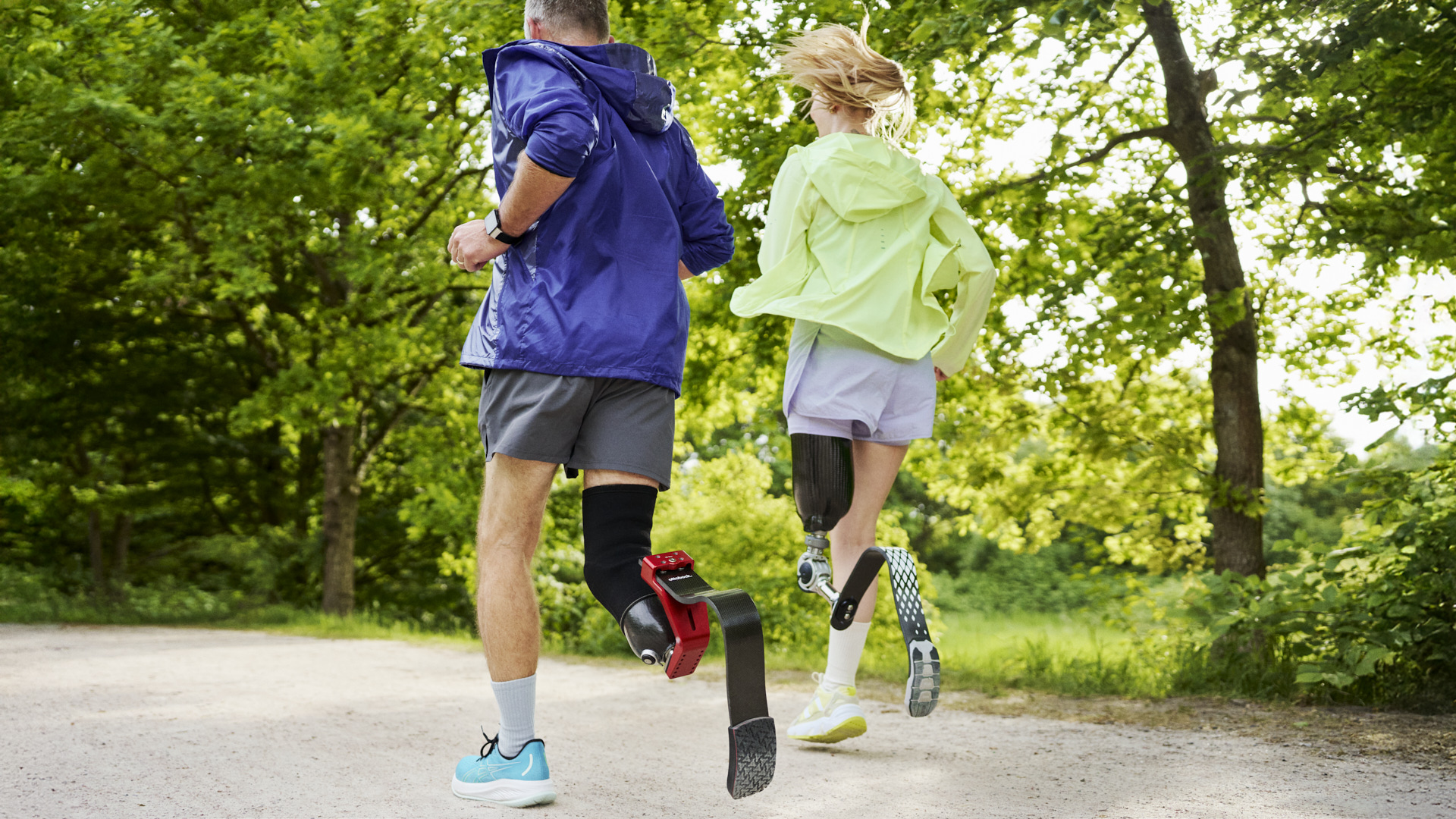 Two runners with Ottobock sports prosthetic running blades training outdoors