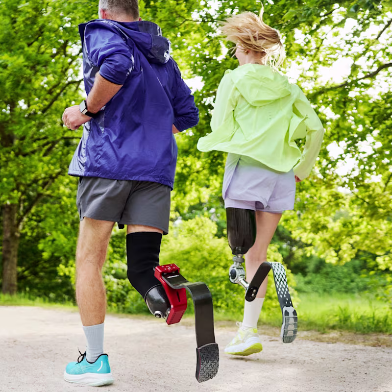 Two runners with Ottobock sports prosthetic running blades training outdoors