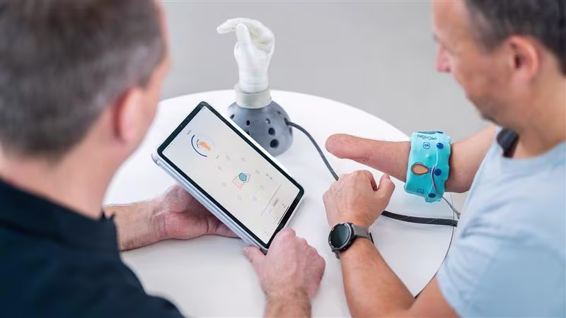 A CPO and a prosthesis user evaluate the michelangelo hand using the myosmart cuff and the connectgrip app.