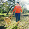 Accompanied by a dog, a female user is walking towards the camera with her Taleo Low Profile carbon foot.