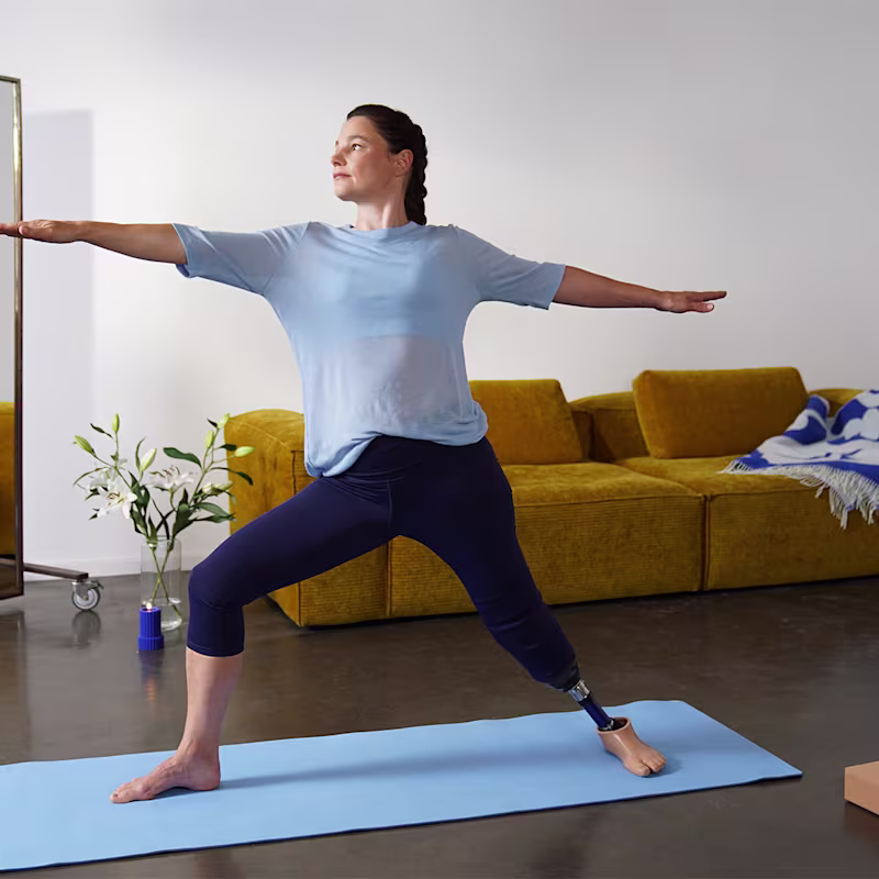 Daniela performing a warrior yoga pose with her Ottobock Evanto prosthetic foot.