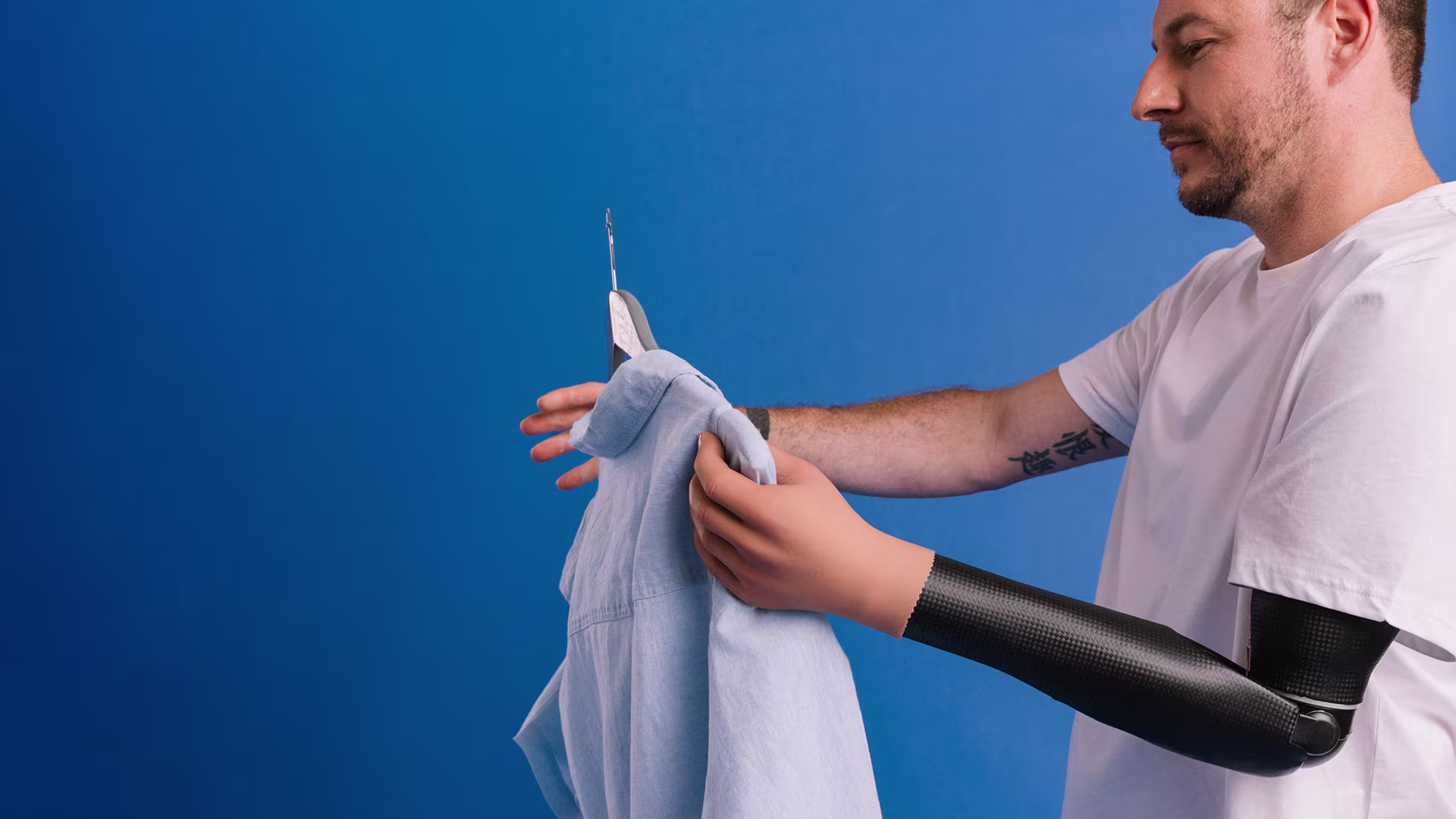 Sebastian using a DynamicArm and Speed Hand, hanging up his shirt.