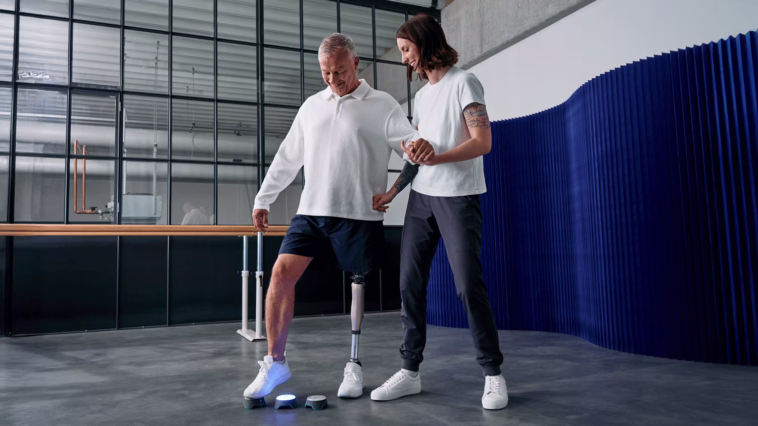 A Certified Prosthetist Orthotist and a lower limb prosthetic patient testing the Kenevo prosthetic knee and Kintrol robotic foot