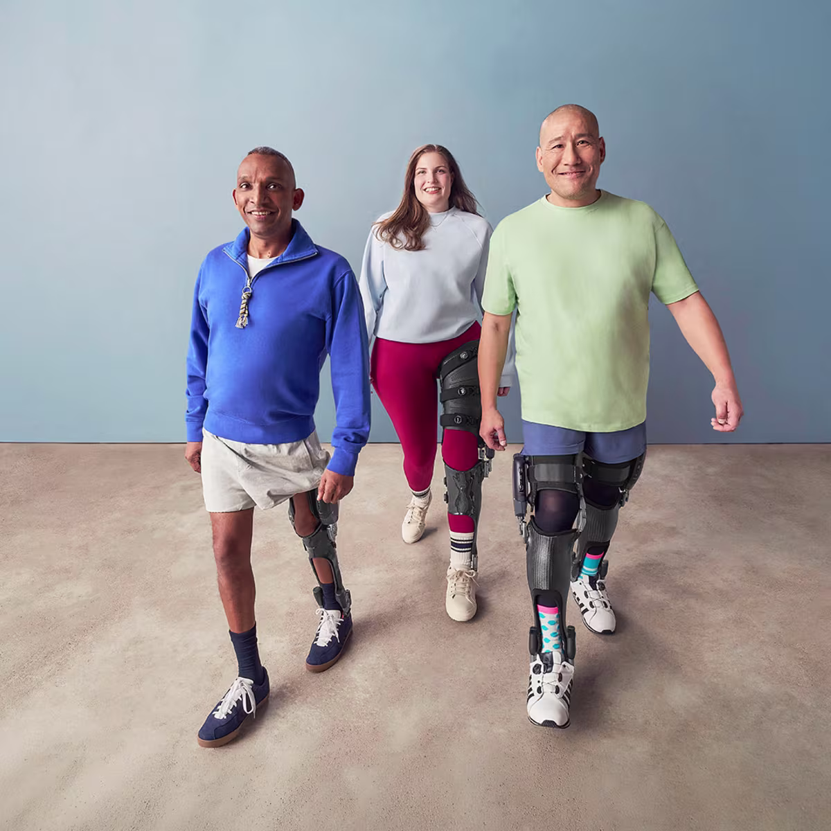 A group of C-Brace users is smiling at the camera while taking a step.