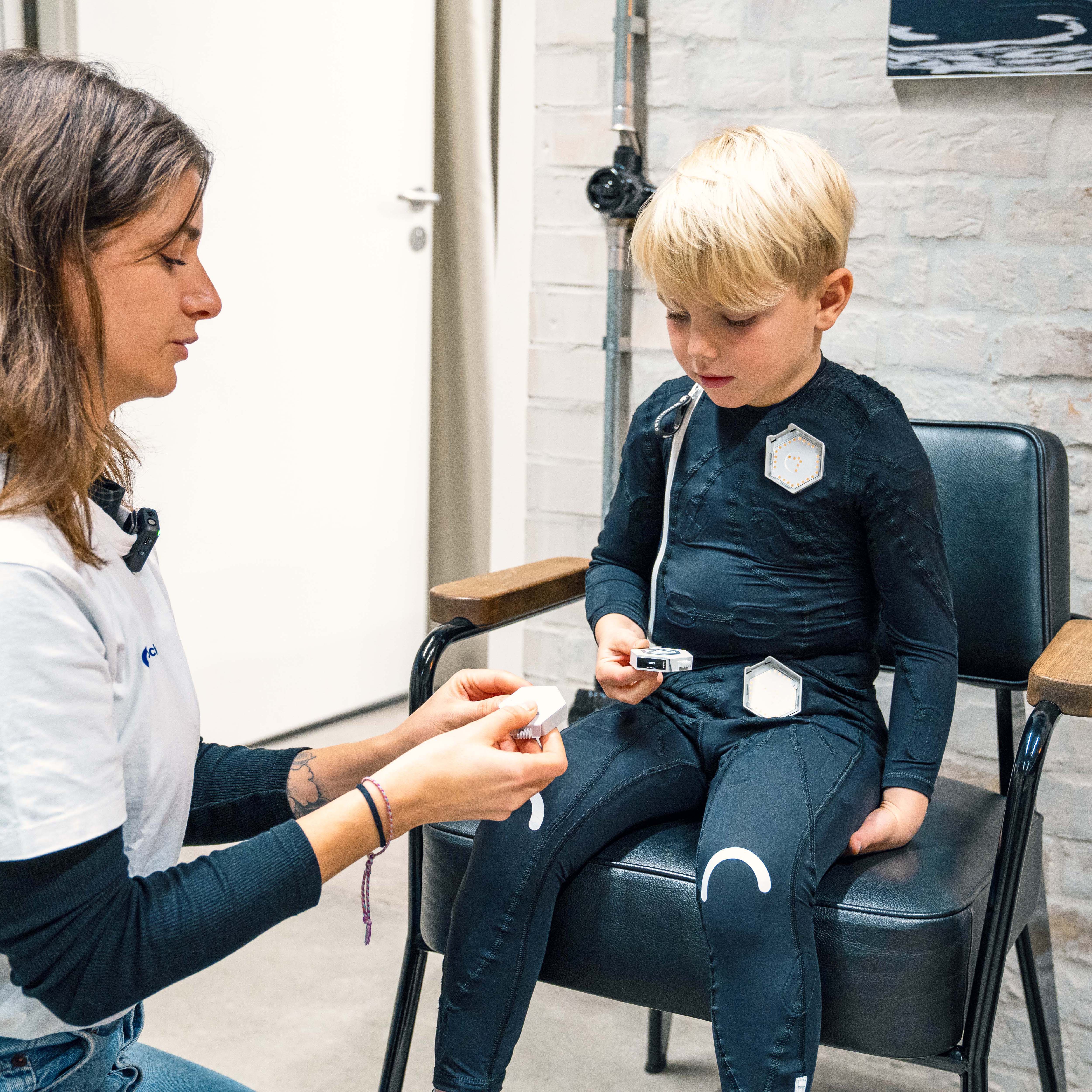 A child with cerebral palsy sitting on a chair 