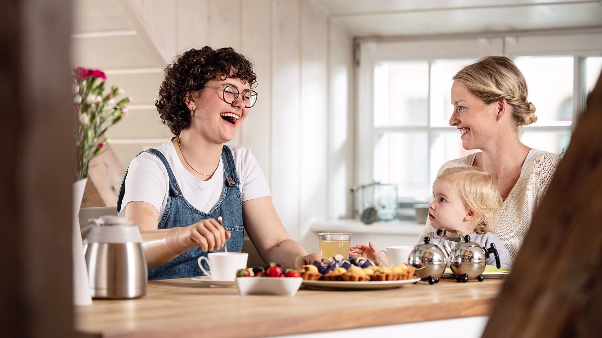 Lina uses her bebionic artificial hand to stir her tea while chatting with her friend during breakfast
