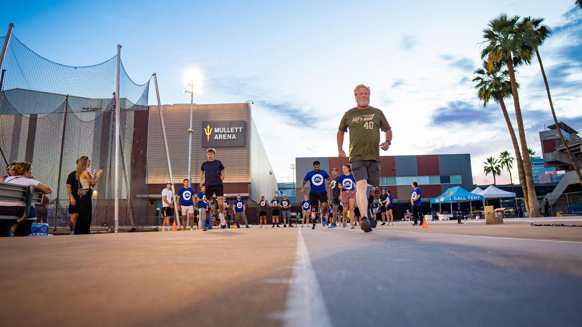 Amputees walking across a running court to test Ottobock prosthetic running blades