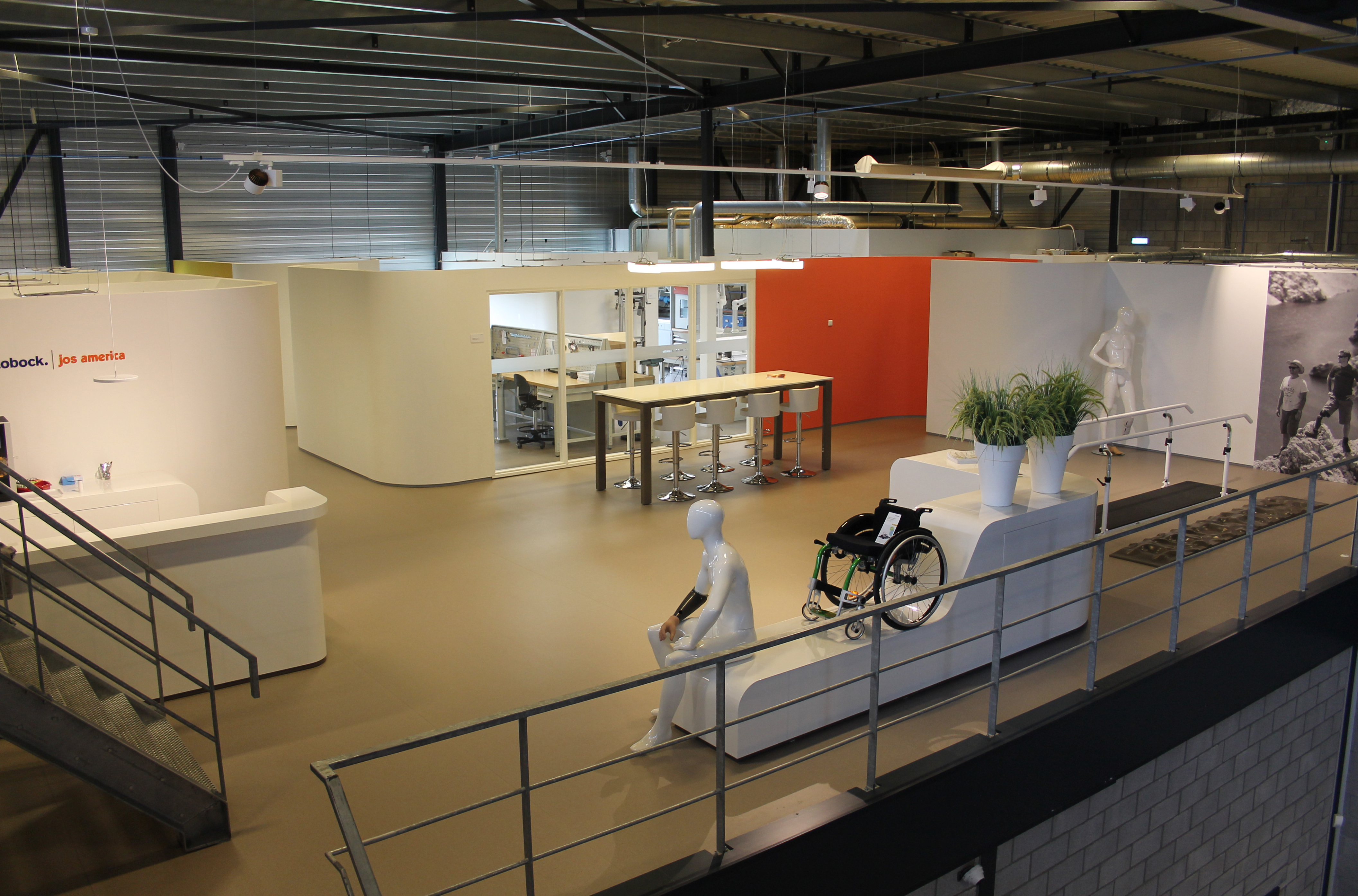 Modern Ottobock workspace featuring reception area, collaborative table, and assistive mobility display.