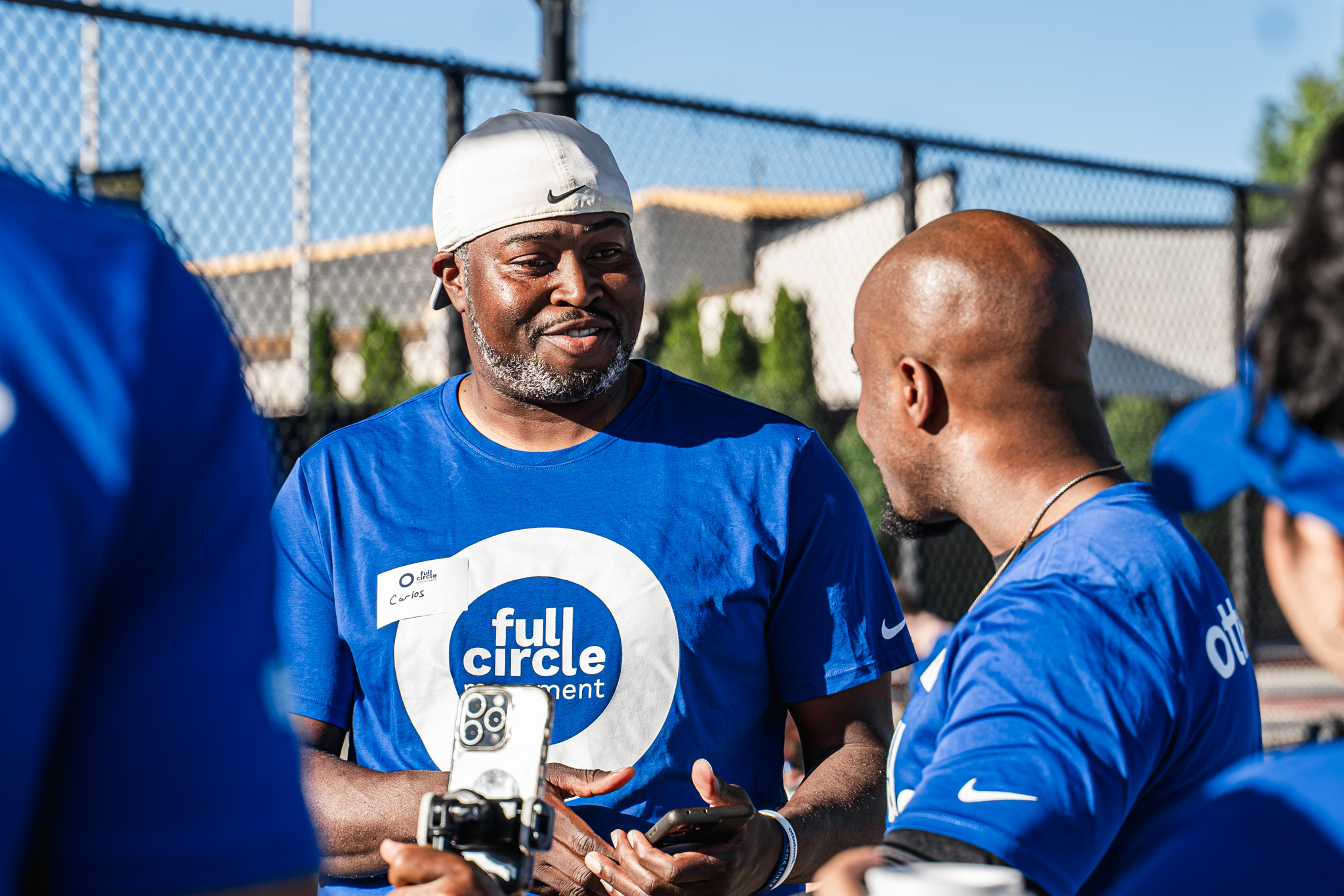 Ambassador and golfer Carlos Brown conversing with a Friends of Ottobock representative at a Full Circle Movement event