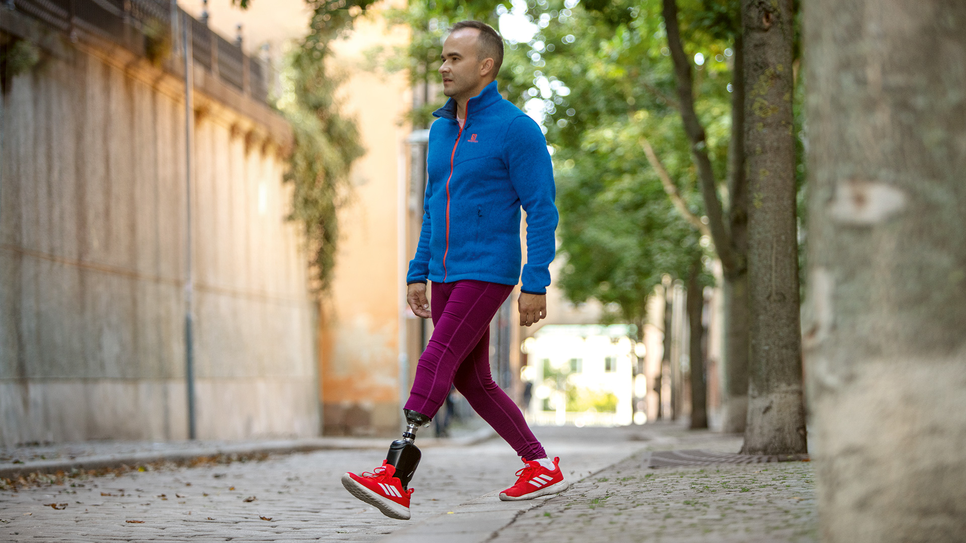 A male individual missing his left foot walks confidently on his Empower Ankle, an advanced prosthesis for veterans.
