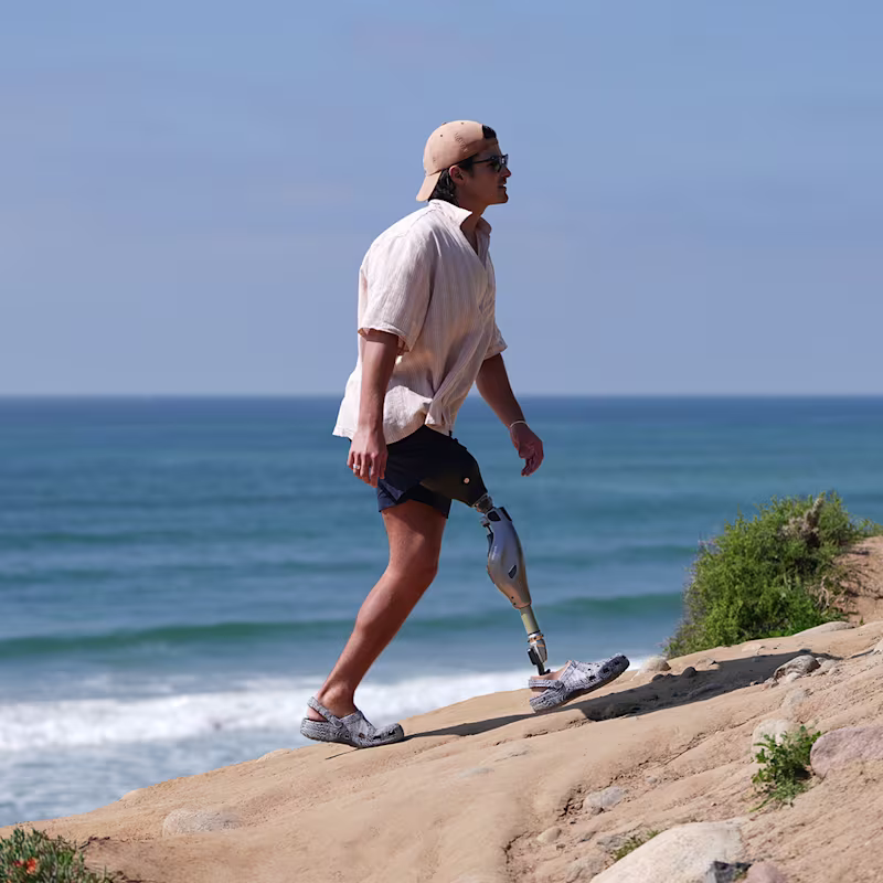 Пользователь протеза с коленным модулем Genium X4 гуляет по побережью.