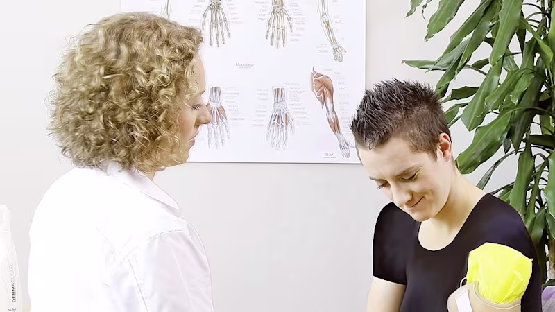 A prosthetic glove touches the tip of the finger of an Ottobock bebionic hand