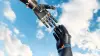 A prosthetic glove touches the tip of the finger of an Ottobock bebionic hand