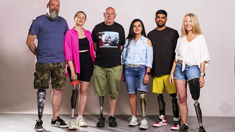 Six users wearing C-Leg's stand against a white background.