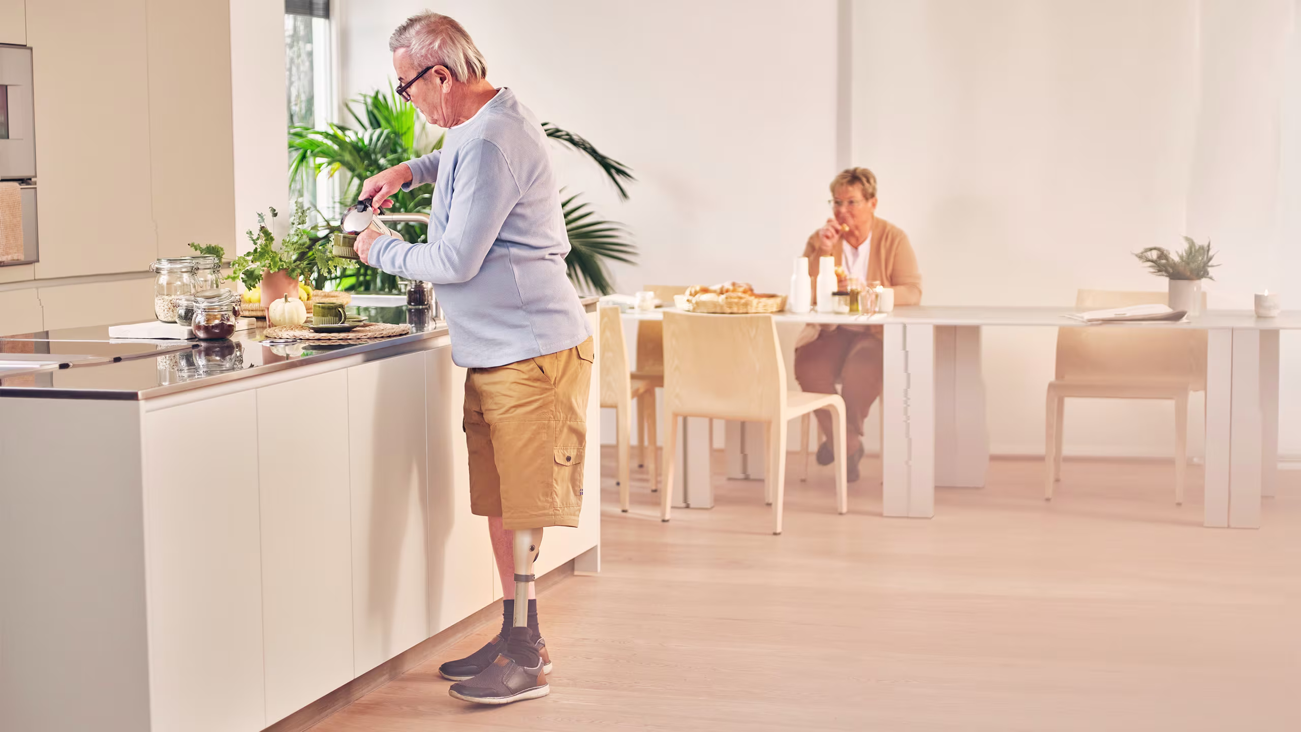 Kenevo user Robert is standing in the kitchen preparing coffee