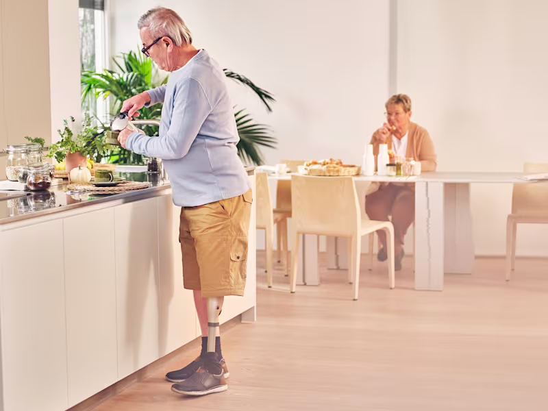Kenevo user Robert is standing in the kitchen preparing coffee
