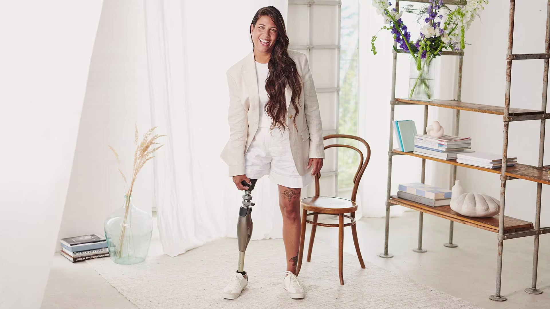 Prosthetic user wearing an Ottobock Genium X4 while standing in her living room.