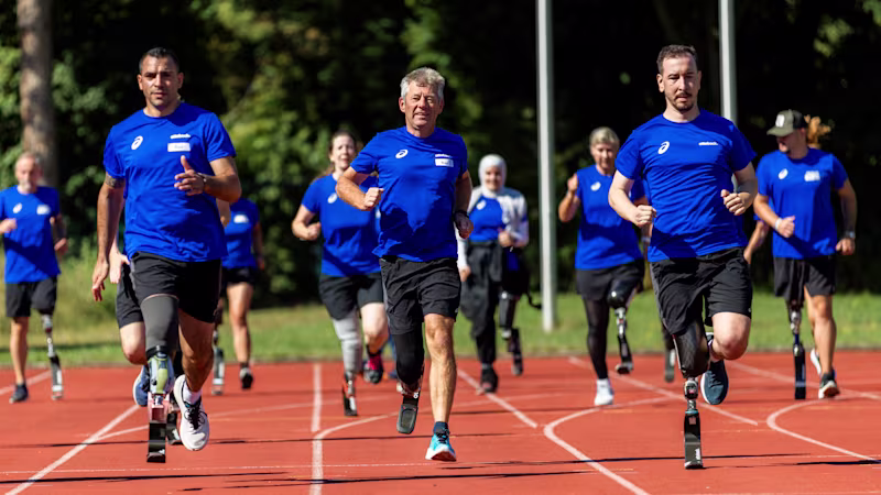 Group of runners with Ottobock prosthetic blades training together on an outdoor track
