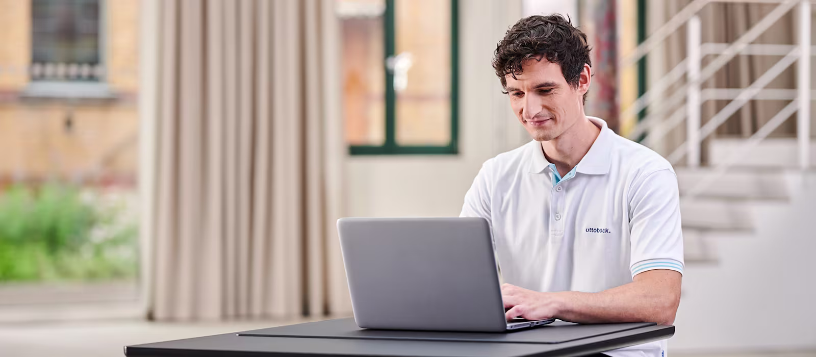An orthopaedic technician is working at a computer.