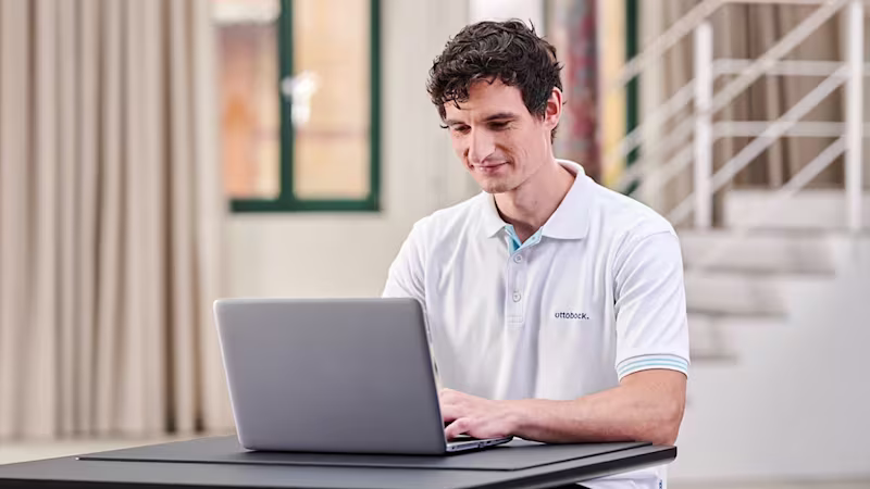 An orthopaedic technician is working at a computer.