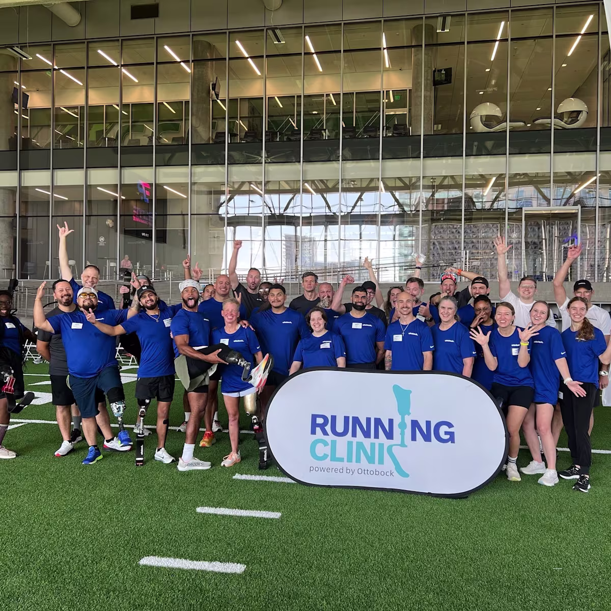 A group of adaptive athletes, coaches, Certified Prosthetist & Orthotist, and volunteers father for a photo for the Running Clinic event hosted by Ottobock