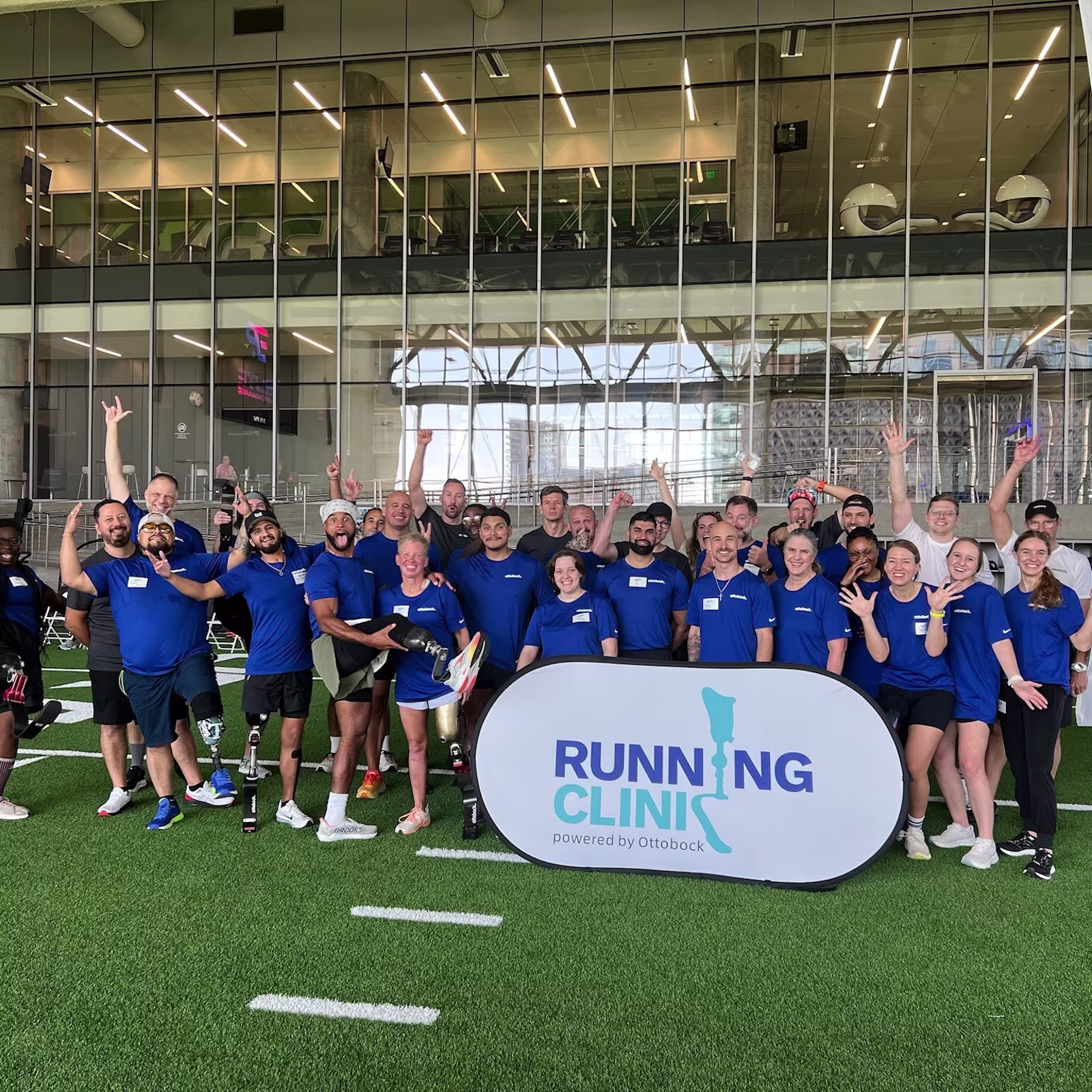 A group of adaptive athletes, coaches, Certified Prosthetist & Orthotist, and volunteers father for a photo for the Running Clinic event hosted by Ottobock