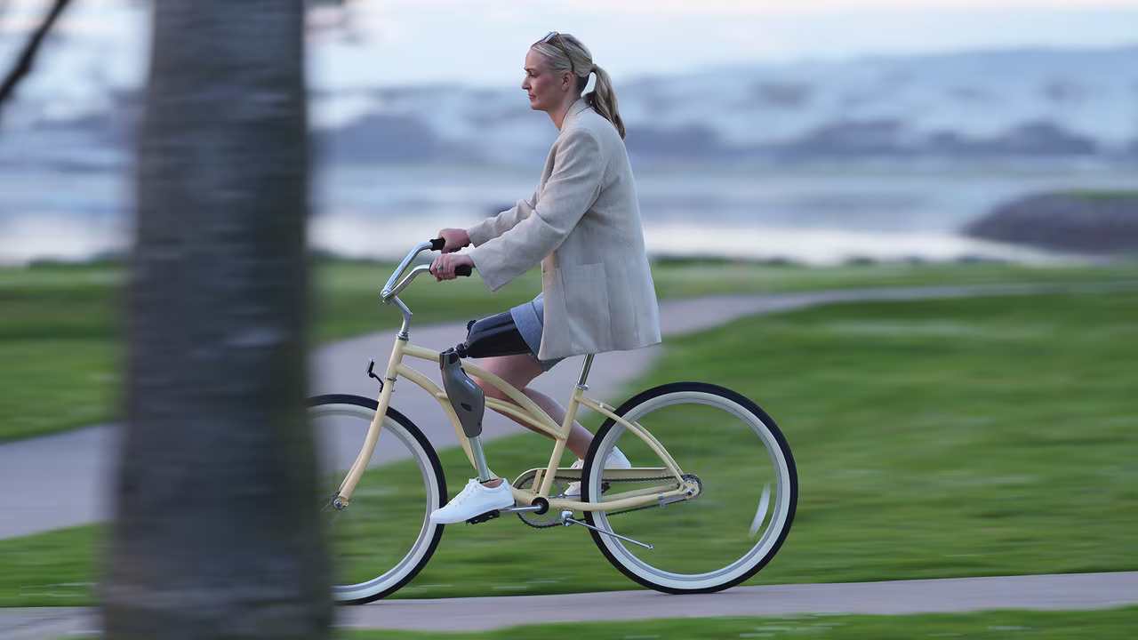 Genium X4 Anwenderin Laura fährt Fahrrad. 