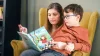 Cerebral palsy patient reading together with his mother