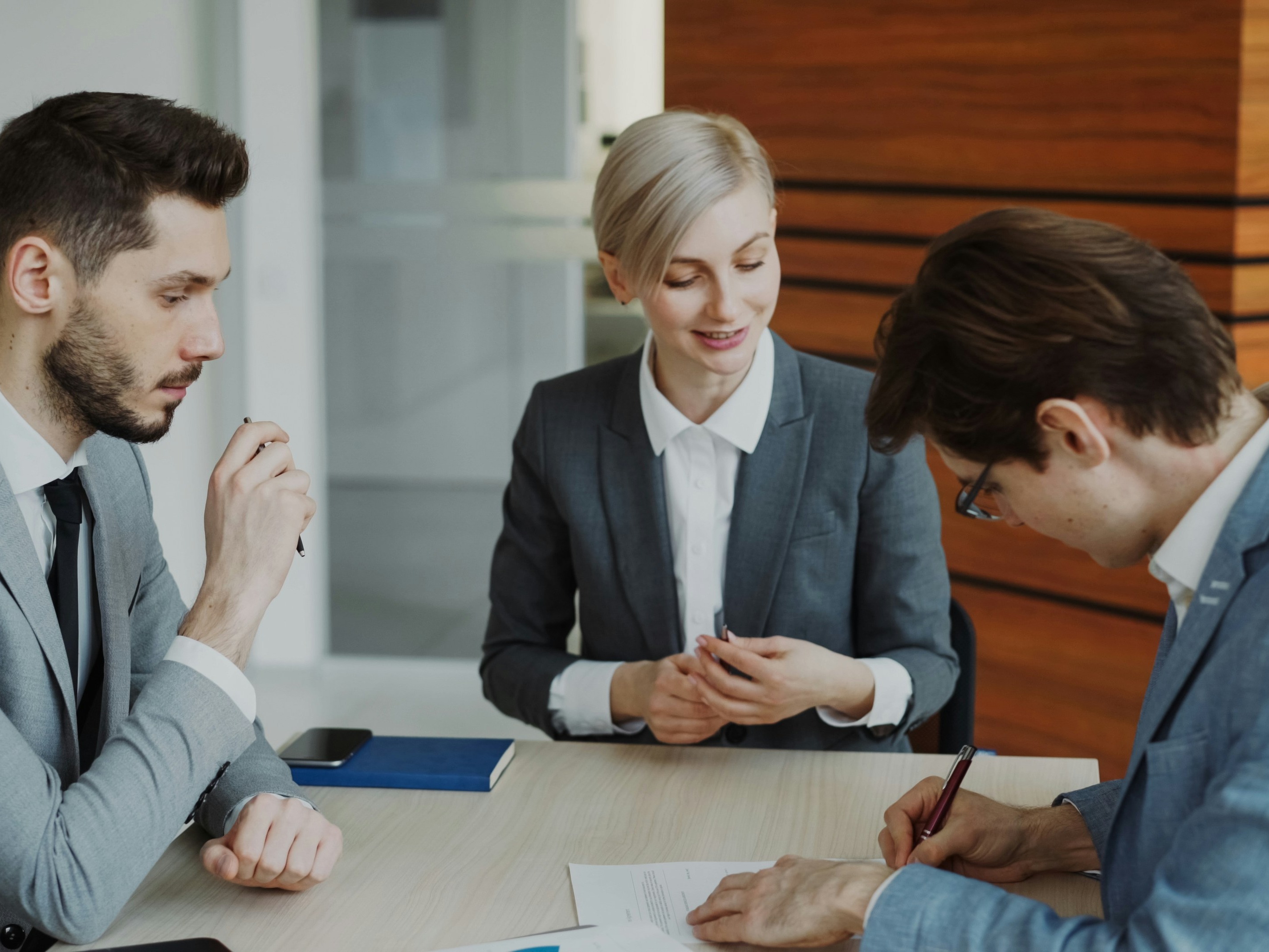 Business professionals drafting up an agreement in a meeting
