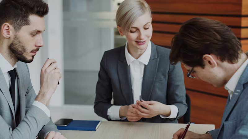 Business professionals drafting up an agreement in a meeting