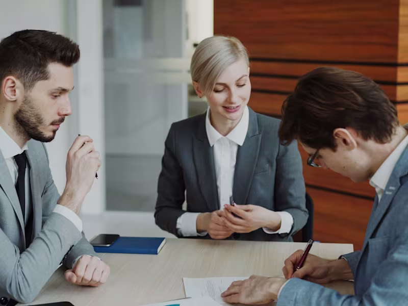 Business professionals drafting up an agreement in a meeting