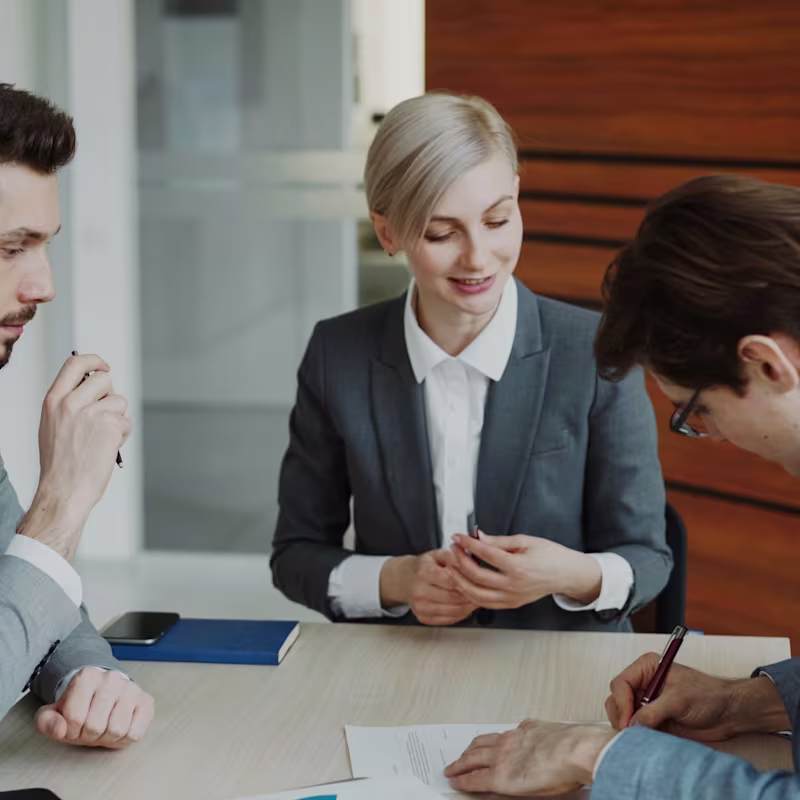 Business professionals drafting up an agreement in a meeting