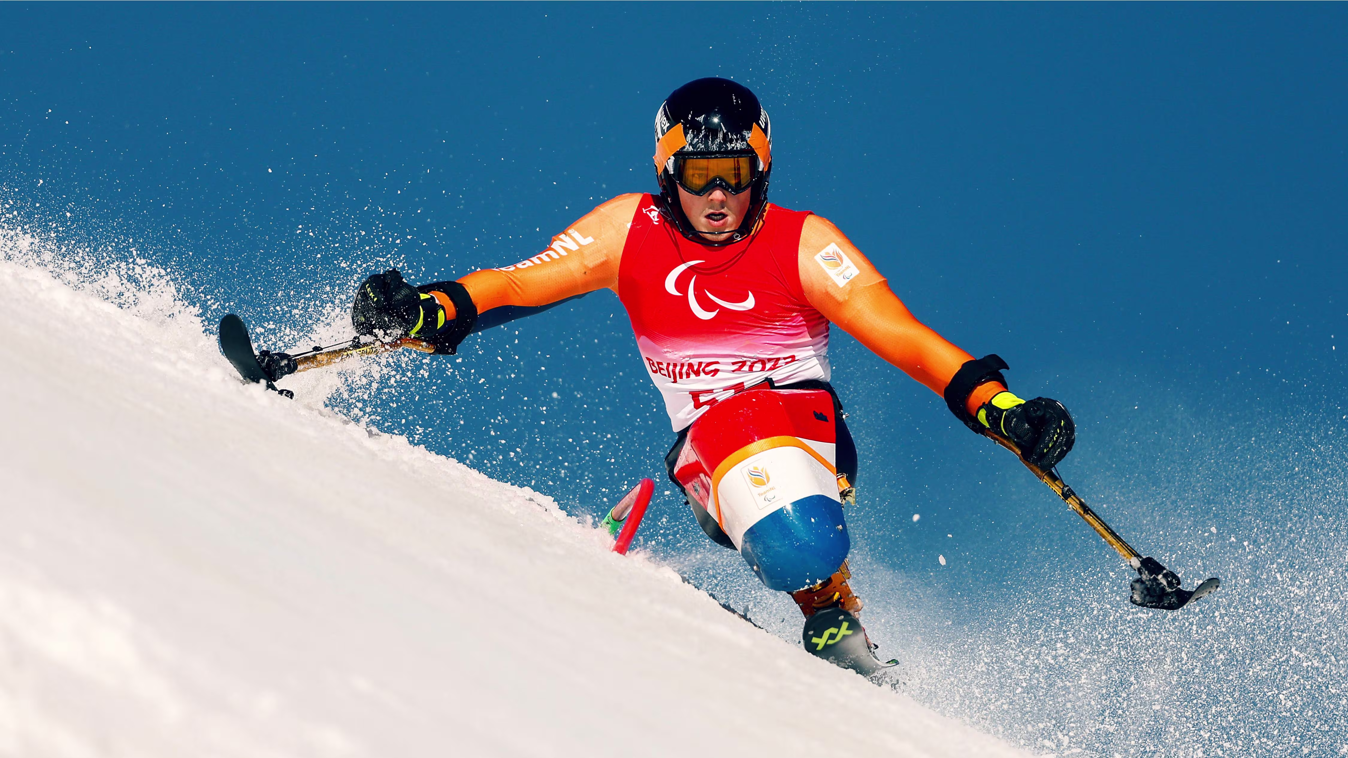 An adaptive athlete skiing in the winter Paralympics on a slope