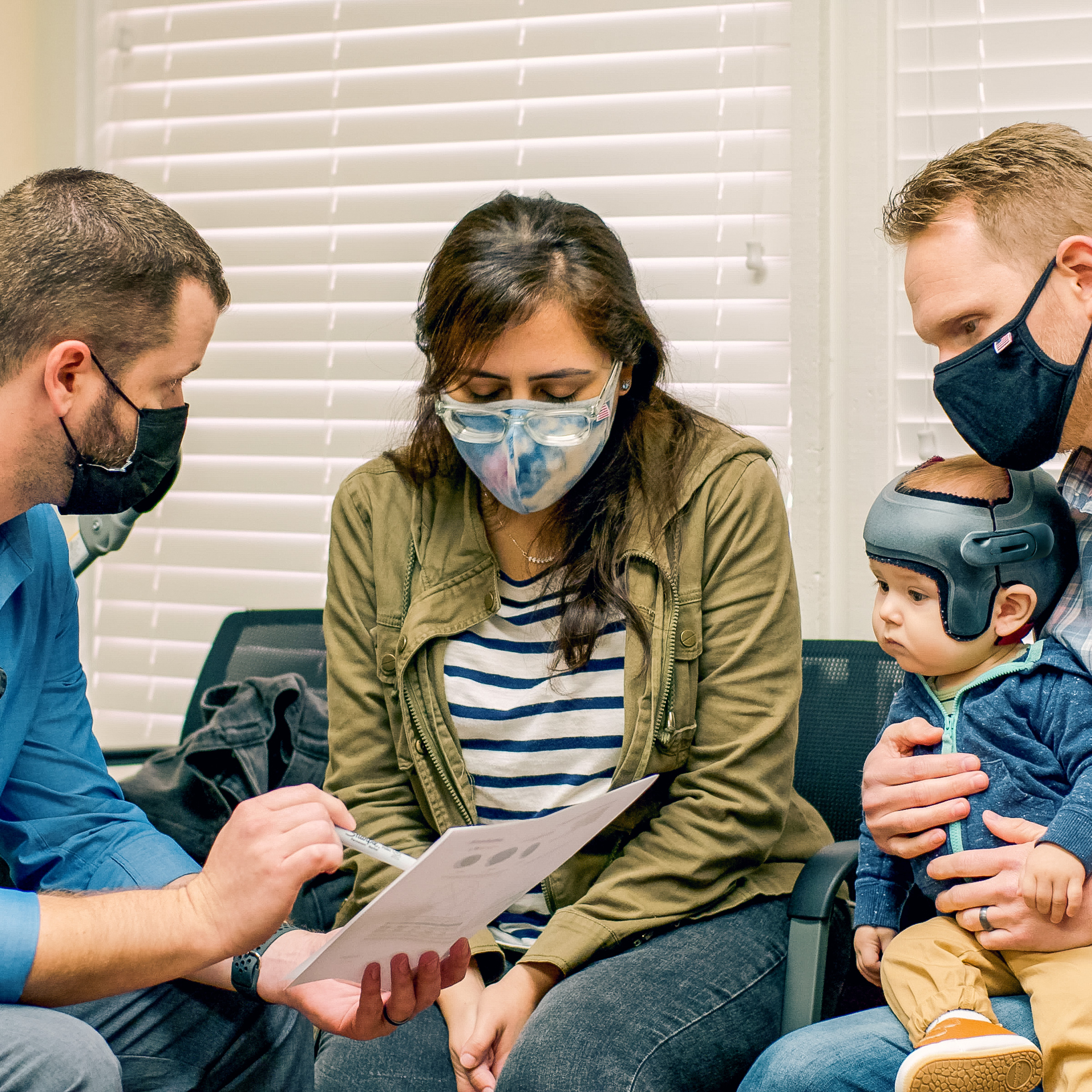 Baby and parents consulting a cranial helmet expert