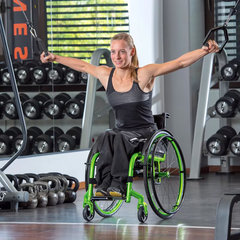 Anna in her Zenit CLT Manual Wheelchair using weights in the gym.