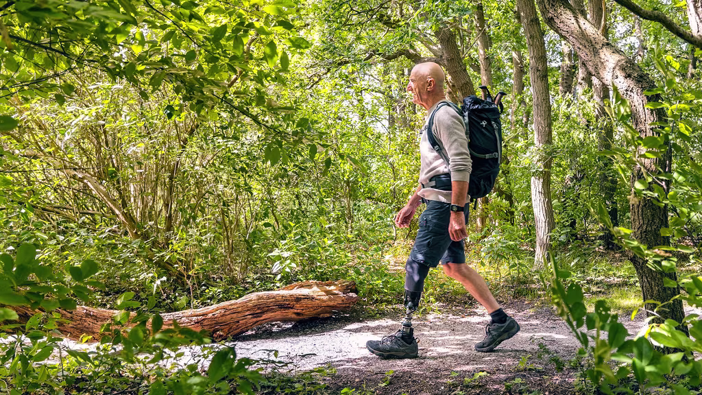 A male user is walking in the forest with his Taleo Harmony prosthetic foot.