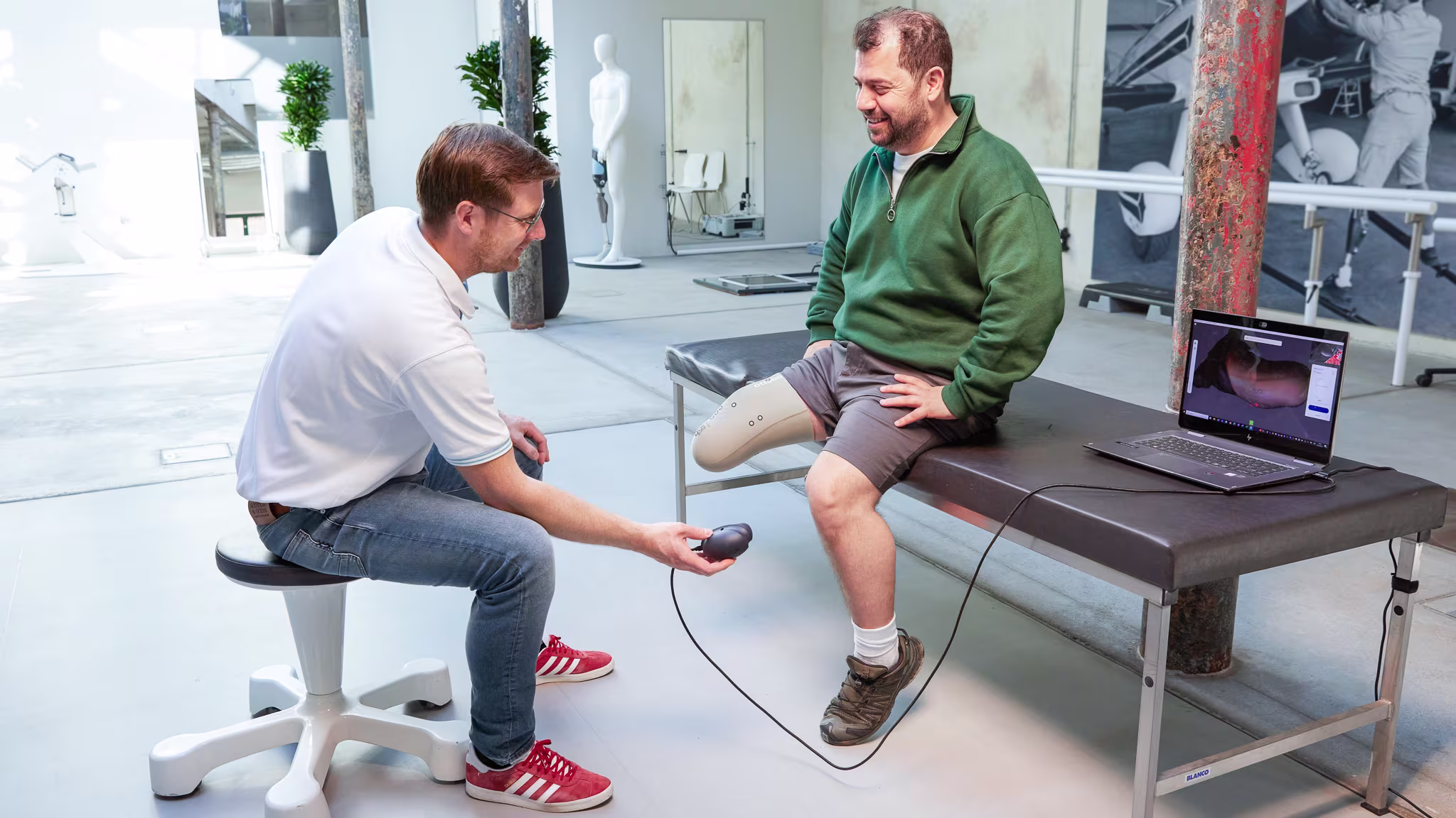 Ottobock technician and prosthetic leg user in a clinical setting scanning a test socket using Transfer Scan Solution.