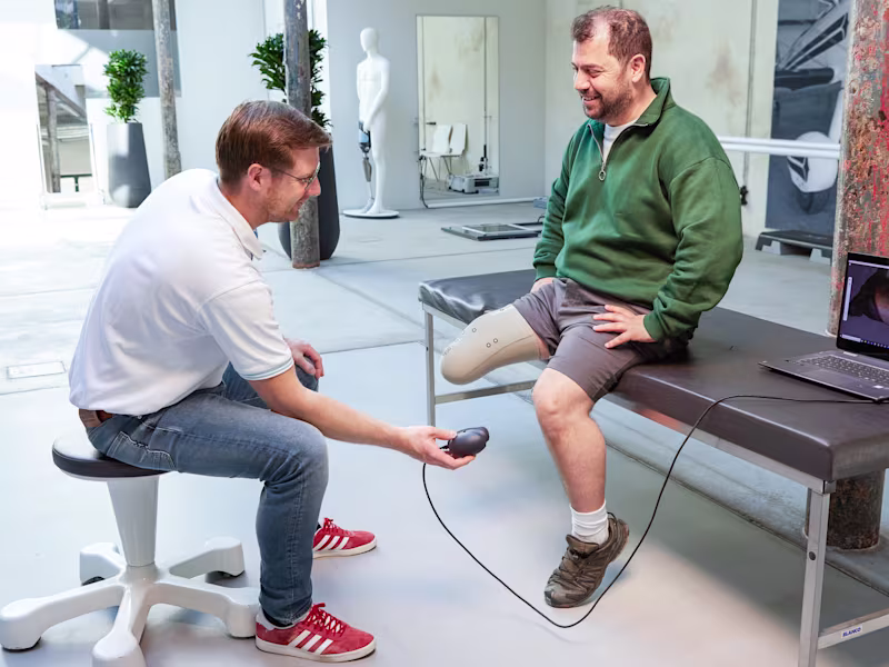 Ottobock technician and prosthetic leg user in a clinical setting scanning a test socket using Transfer Scan Solution.