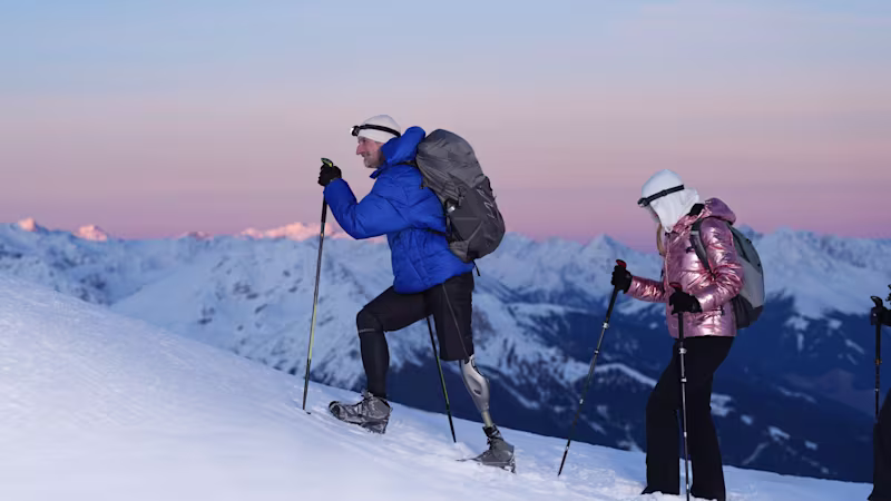 An amputee wearing his Ottobock Genium X4 while hiking in the mountais with his friends.