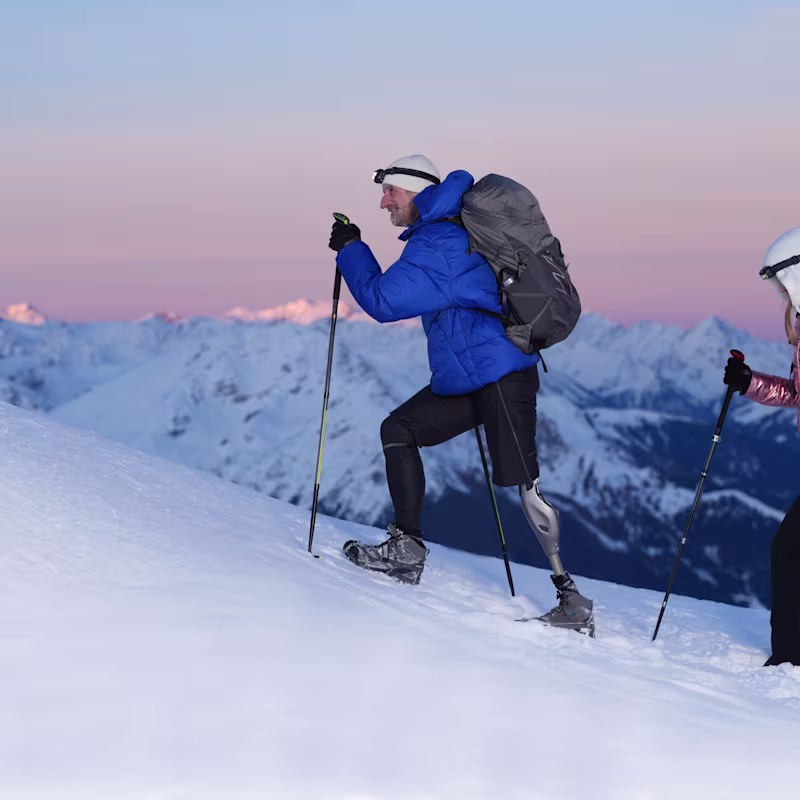 An amputee wearing his Ottobock Genium X4 while hiking in the mountais with his friends.