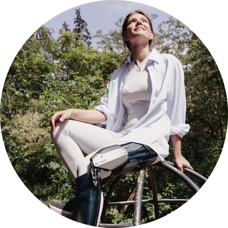 C-Brace user Sina sitting on top of a black climbing frame