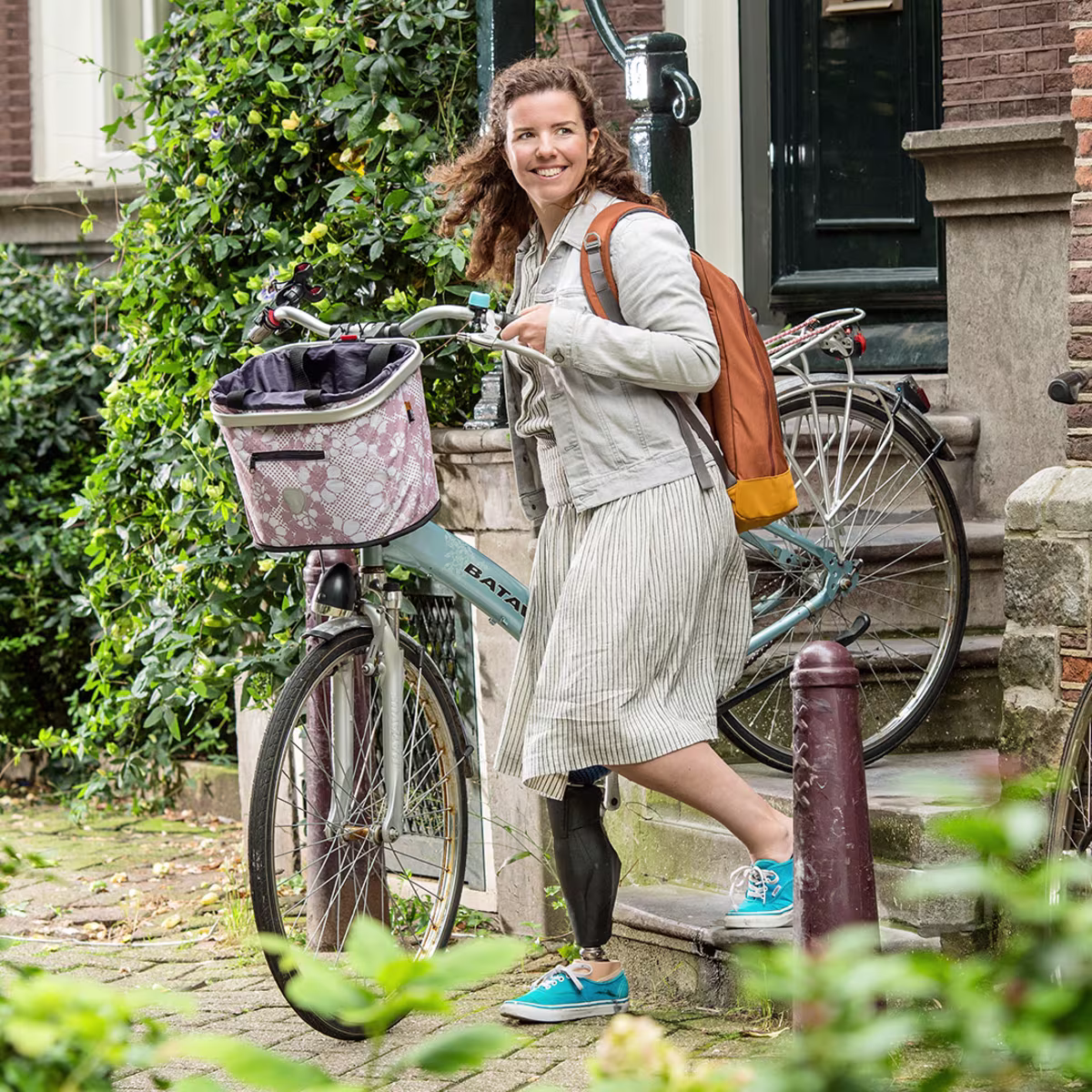 A girl brings her bicycle down the stairs while wearing an Ottobock Taleo Side Flex foot prosthesis