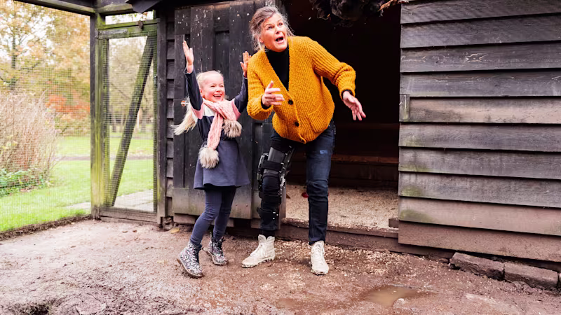 Ottobock C-Brace orthosis user with her grandchild in the henhouse