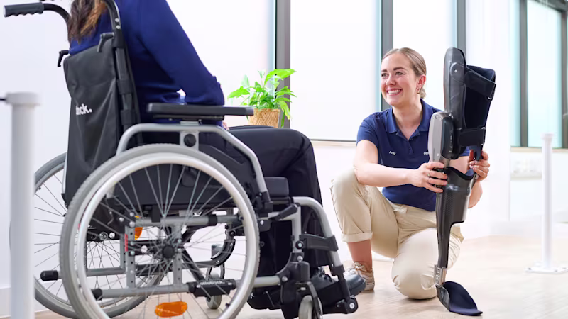 Ottobock UK Academy Clinician Amy McColm holding a C-Brace orthosis.