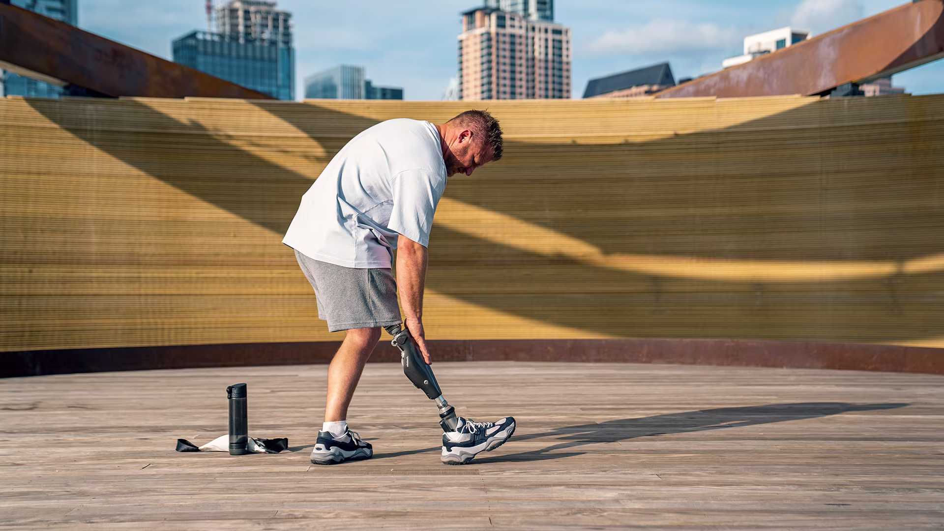A male user taps his C-Leg before starting to work out.