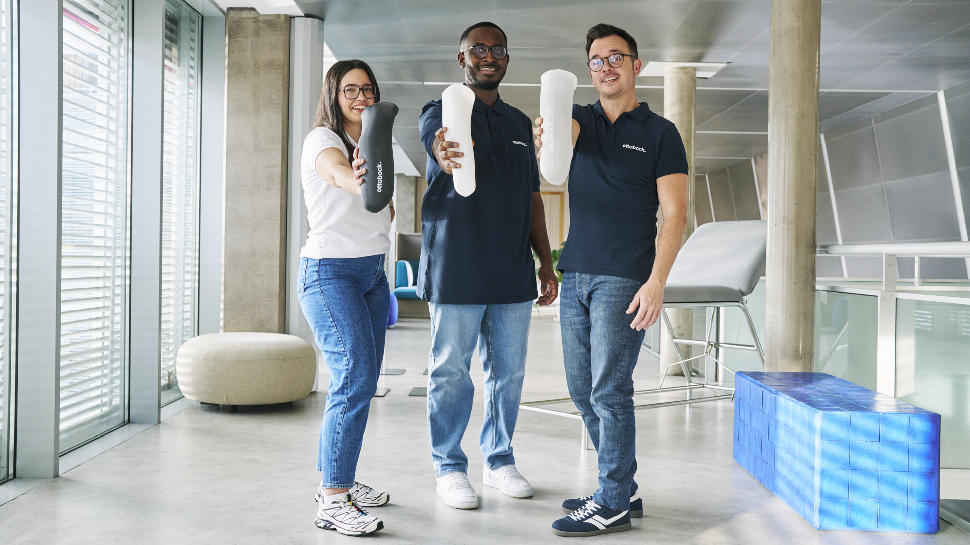 Three Ottobock team member holding Ottobock liners